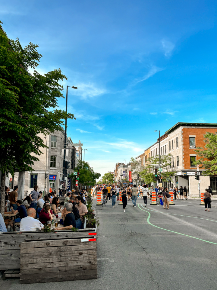 A busy Montreal terrasse on a sunny day. The adjoining street is closed to car traffic.